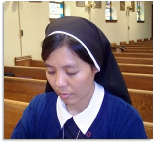 Sister praying in the chapel