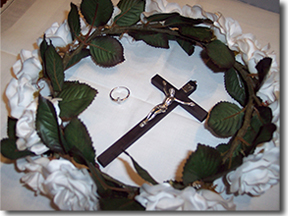 Wreath of white roses, crucifix and ring